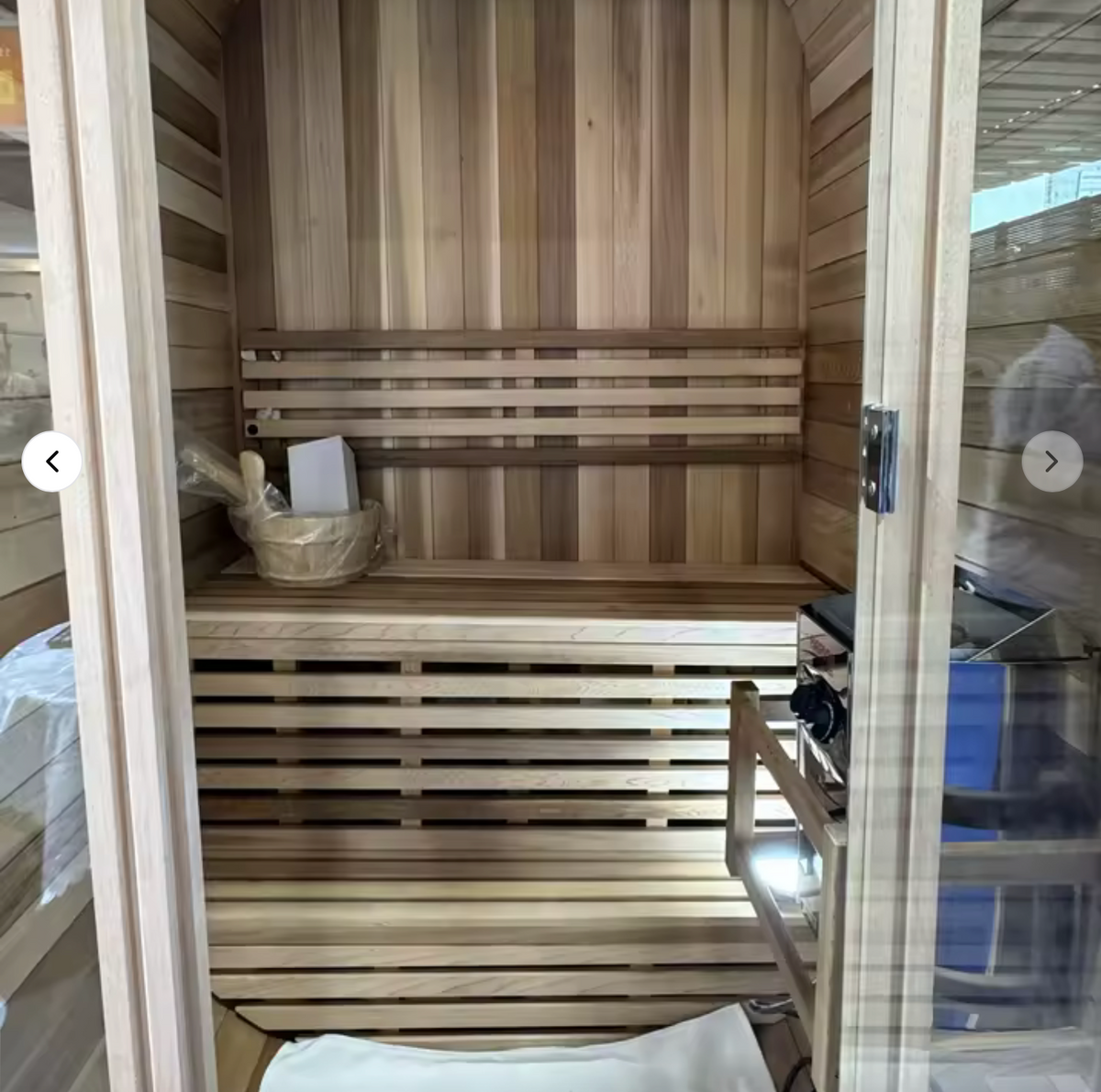 Auris One outdoor cedar sauna, rear view showing the cedar cladding and steel bands